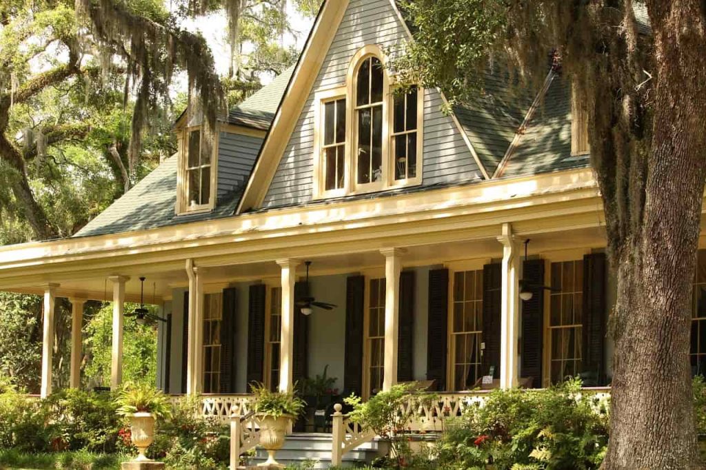 Façade de maison ancienne avec de grandes fenêtres, évoquant le charme et potentiellement des économies avec des fenêtres qui vous remboursent.